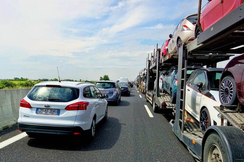 cars and a transporter on the highway